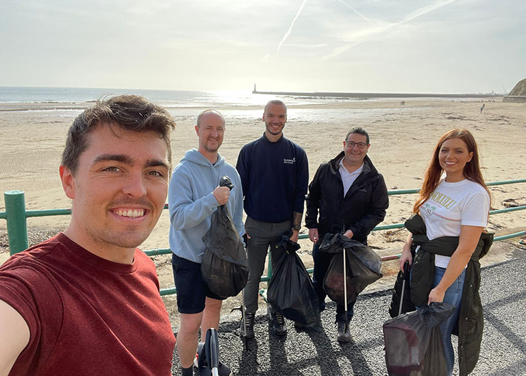 Waterman Aspen in the Community - Team photo Litter Picking at Sunderland Beach